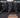 Wall mounted Concept2 SkiErgs above a row of RowErgs in a CrossFit gym