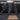 Wall mounted Concept2 SkiErgs above a row of RowErgs in a CrossFit gym