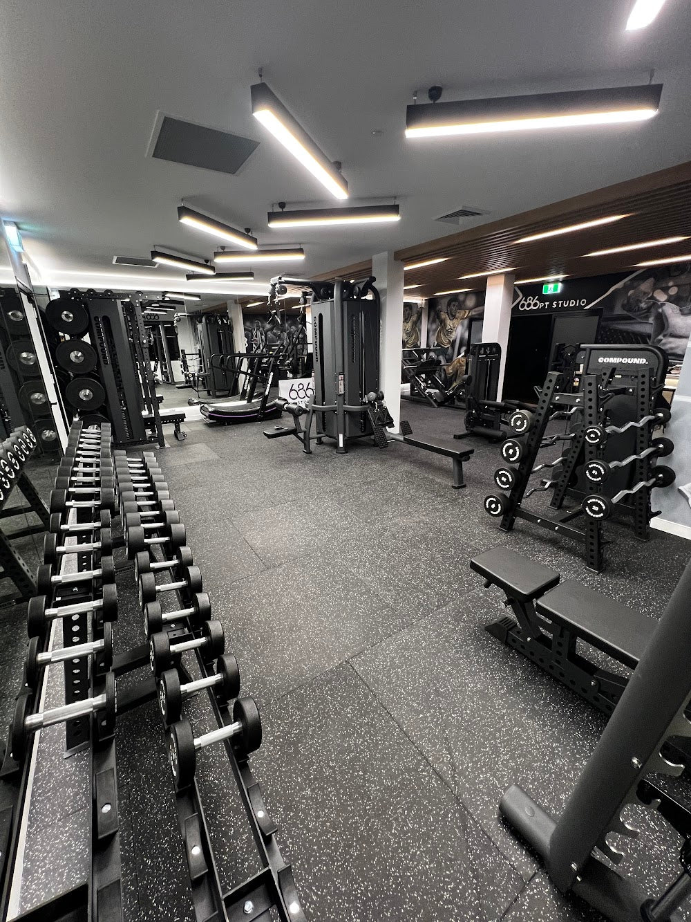 Deep view down a boutique PT studio floor by Compound Fitness