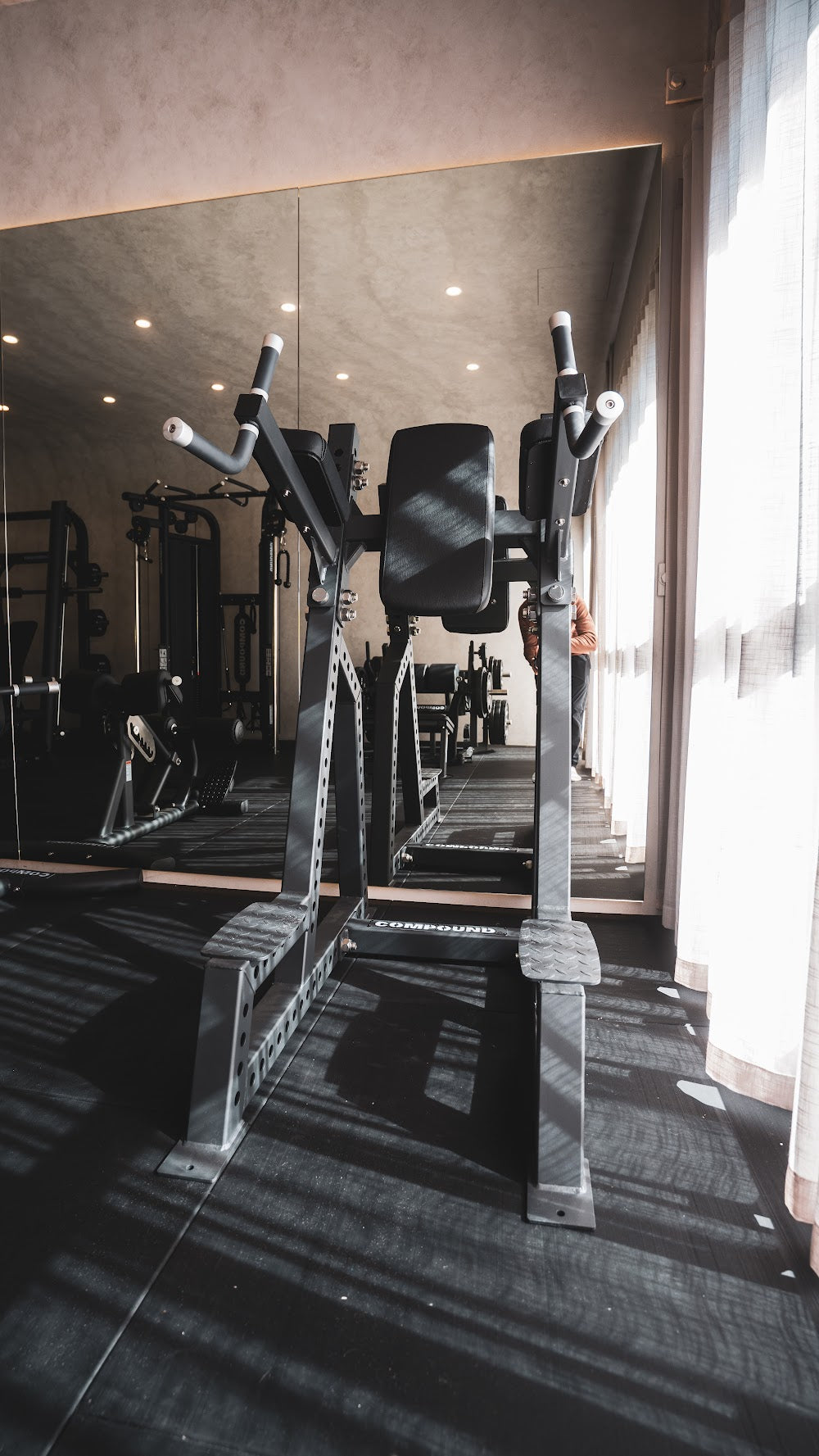 Machine floor with mirror and natural light in a boutique studio by Compound Fitness