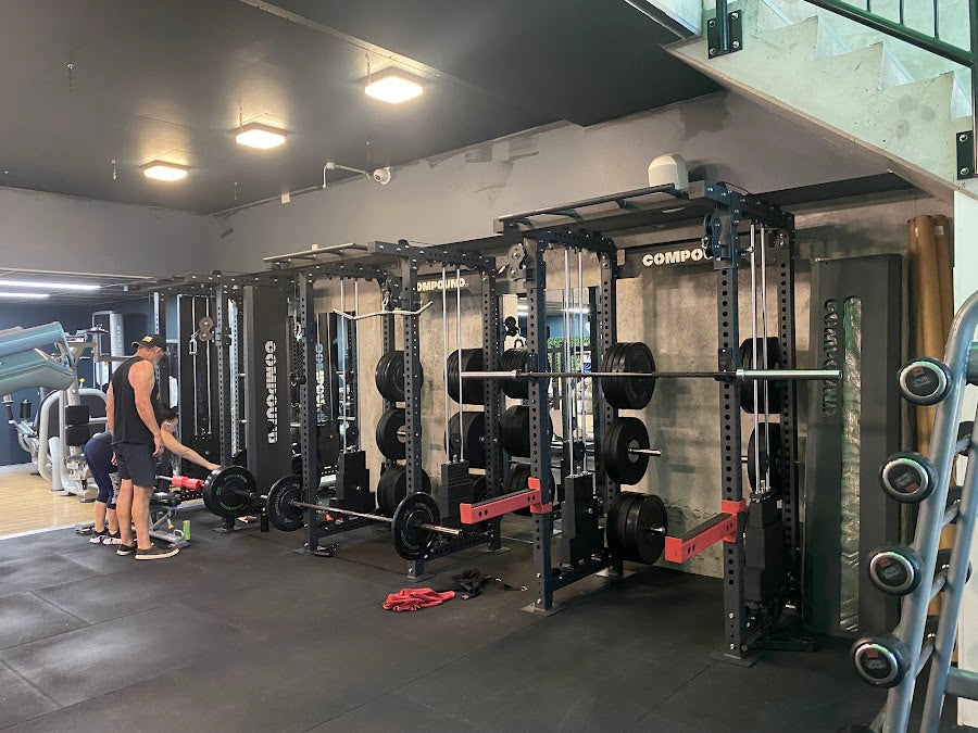 Power racks and functional rig across a 24/7 gym floor by Compound Fitness