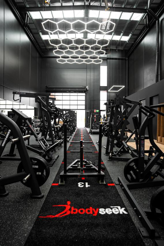 Sled and prowler turf lane through a 24/7 gym fitout by Compound Fitness
