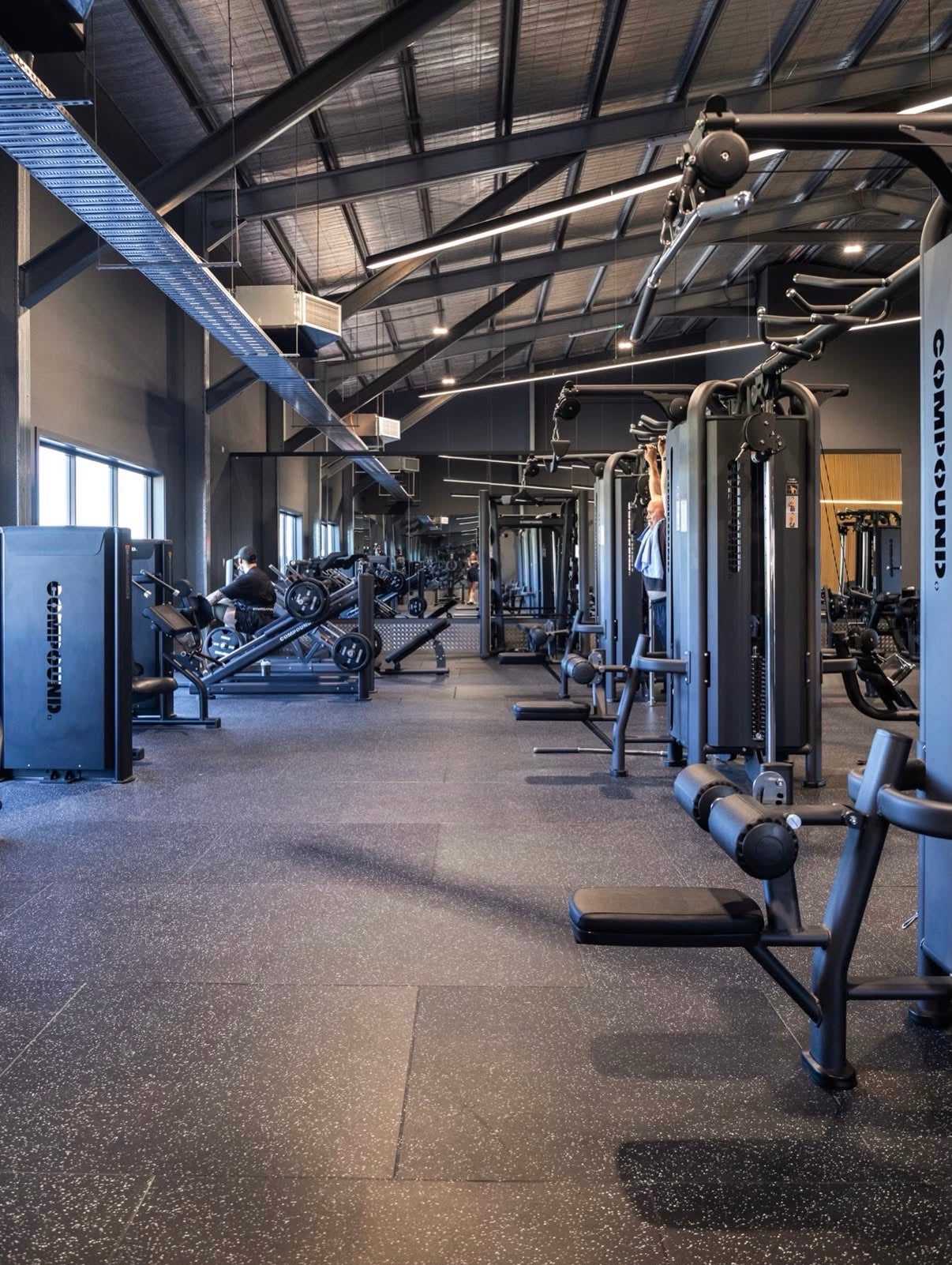 Full machine floor with mirrors and natural light in a 24/7 gym fitout by Compound Fitness