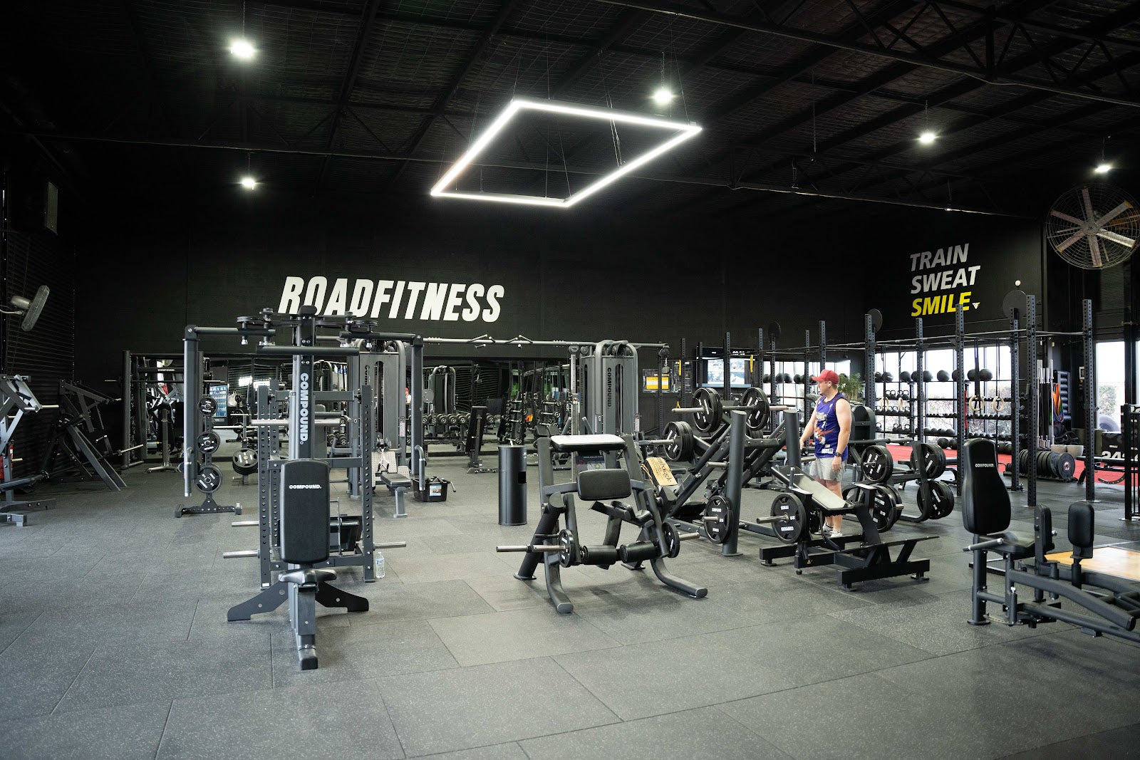 Full 24/7 gym floor with racks, benches and machines by Compound Fitness
